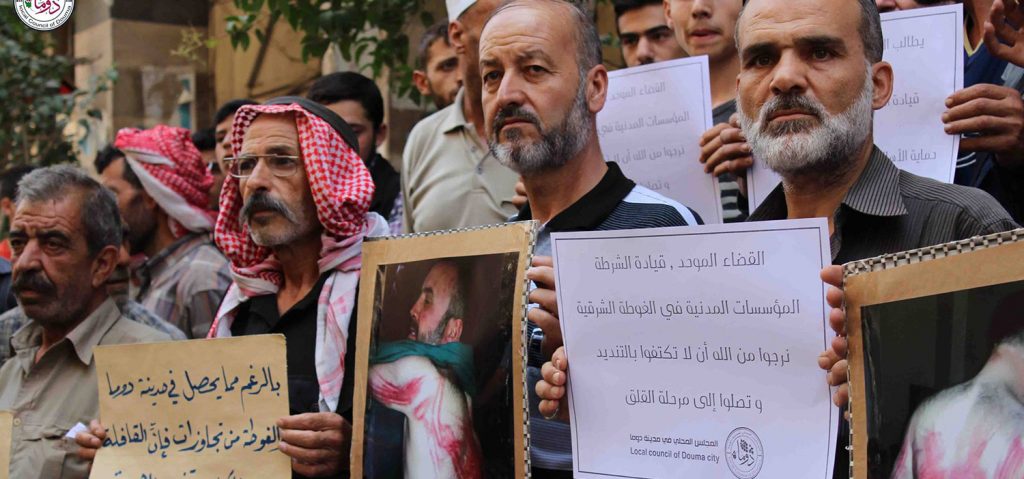 Residents in the rebel-held town of Douma hold a protest after a member of the local council is kidnapped and tortured. Source: Facebook/Local Council of Douma